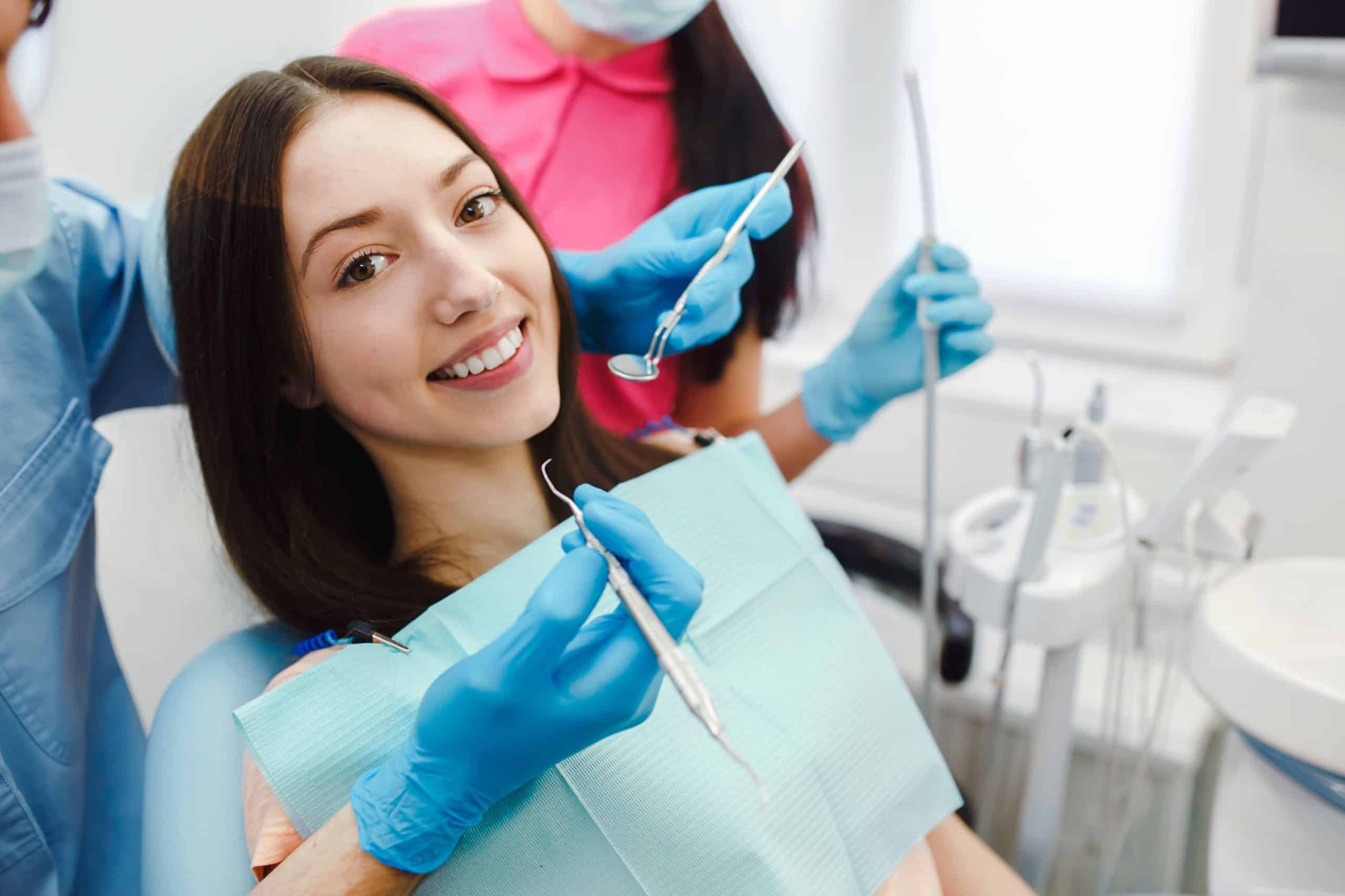 smiling-woman-dentist-chair-1-scaled.jpg